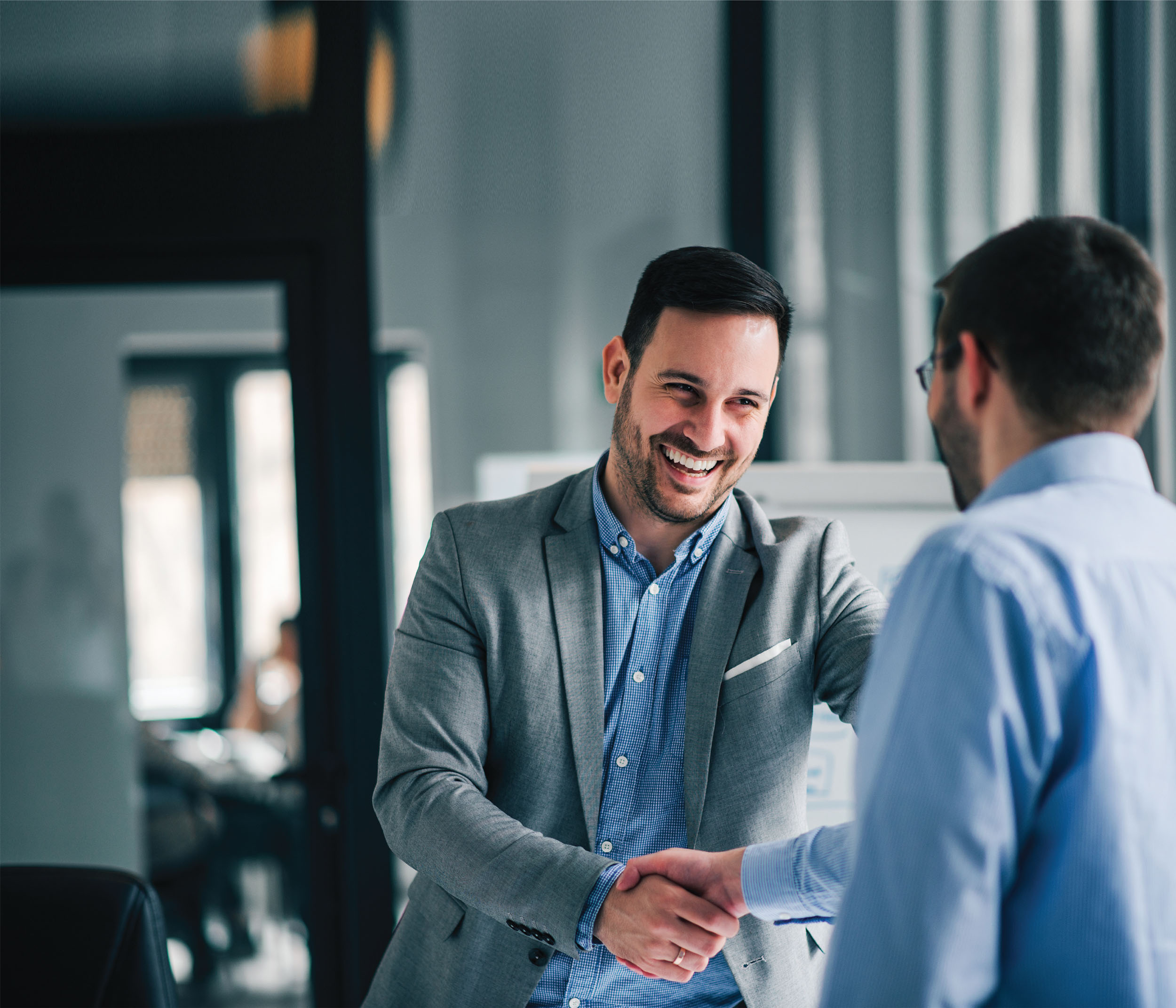 Two men shake hands - stock image